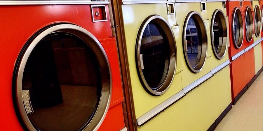 a row of washing machines in a laundromat
