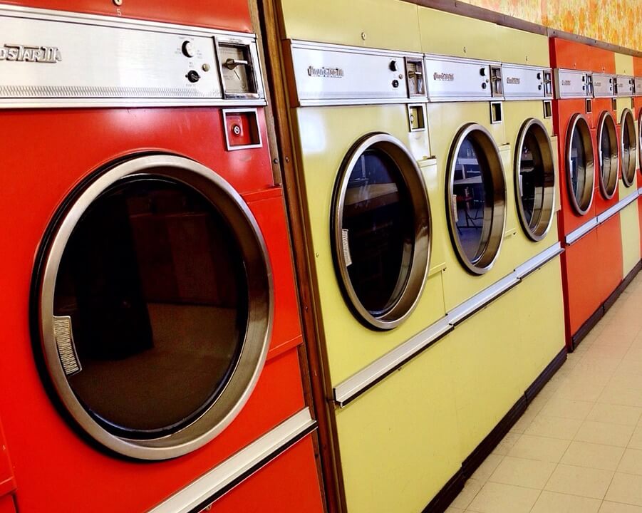 a row of washing machines in a laundromat