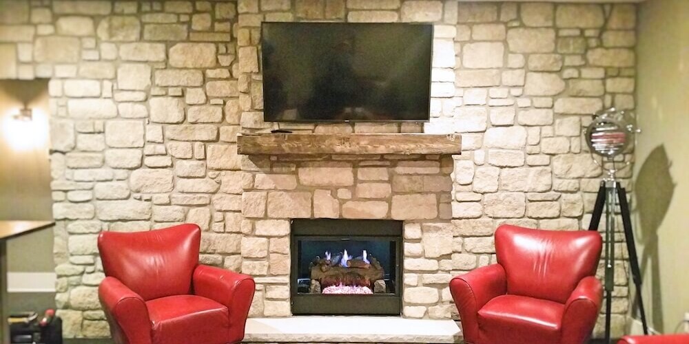 stone accent wall and fireplace with mantle